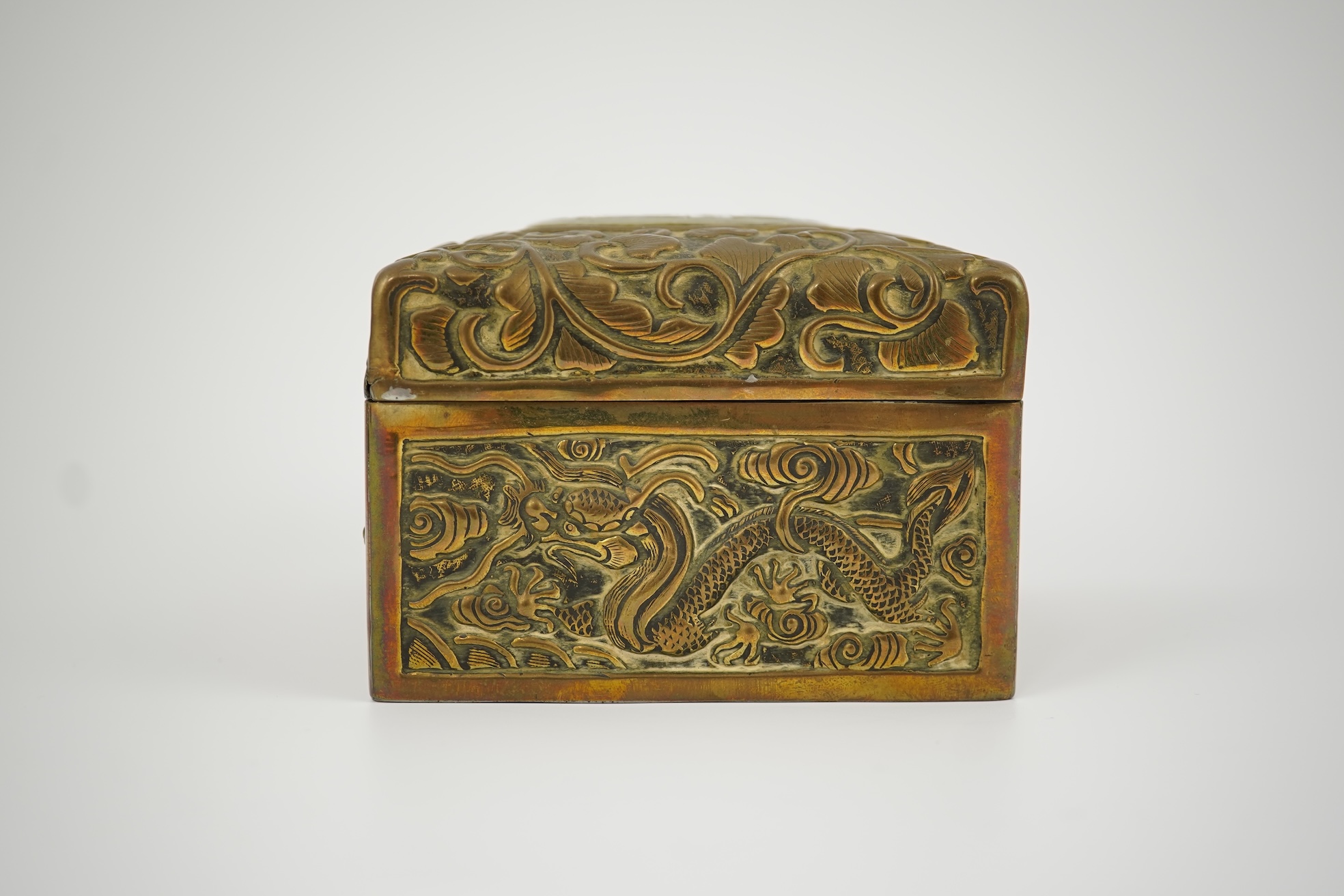 A Chinese brass 'dragon' box, inset with a 17th/18th century jade plaque
